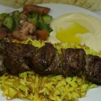Lamb Kabab · Lamb Leg Pieces on a Skewer Grilled and Served on a Bed of Rice with your Choice of Sides.