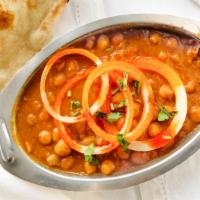 Chana Masala · Chickpeas cooked with onion, chopped tomatoes and traditional spices.