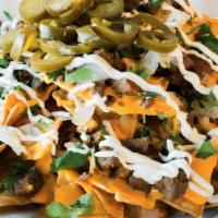 Meat Nachos · Nacho cheese or shredded cheese, your favorite meat, beans, pico de gallo, sour cream, and j...