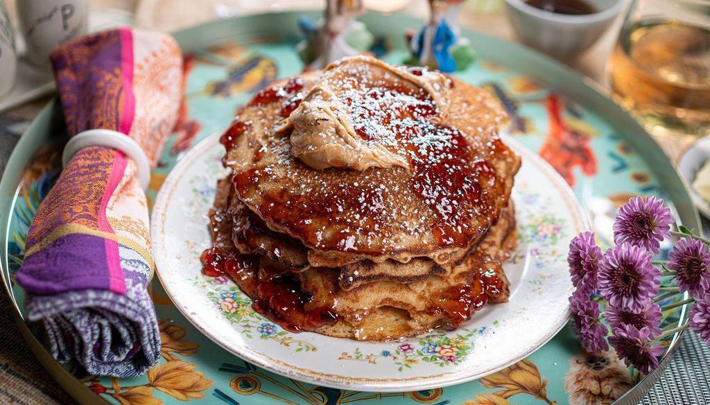 Smothered Pbj Pancakes · 4 griddled buttermilk pancakes, smothered with chunky peanut butter and grape jelly, maple syrup, butter