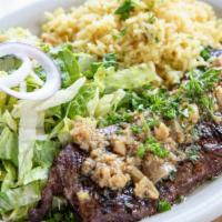 Entraña Al Ajo · Certified angus beef skirt steak topped with sautéed garlic & parsley.