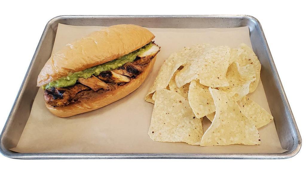 Grilled Chicken Torta · Bolillo roll, grilled chicken, guacamole, refried beans, tortilla chips.