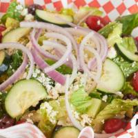 Greek Salad · Crisp Romaine lettuce, red onion, cucumber, cherry tomatoes, Kalamata olives, and feta cheese.