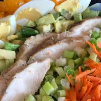 Asian Cobb Salad · Crisp Romaine lettuce, grilled skinless chicken breast, shredded carrots, avocado, green oni...