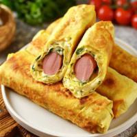 Breakfast Burrito With Eggs, Cheese & Sausage · Fluffy scrambled eggs, savory breakfast sausage home fries and melted cheddar cheese with pi...