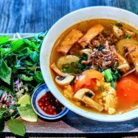 Bun Rieu · Our tomato-based noodle soup w/ vermicelli noodles, tomatoes, imitation fish cake, mushroom,...
