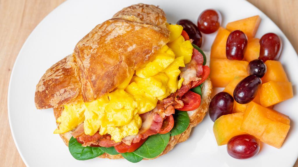 Morning Croissant ** · Scrambled egg, bacon, havarti, spinach and tomato on a croissant. Includes a side of seasonal fruit.
 **Please note that in the event we are out of croissants, the sandwich will be made on multigrain bread**