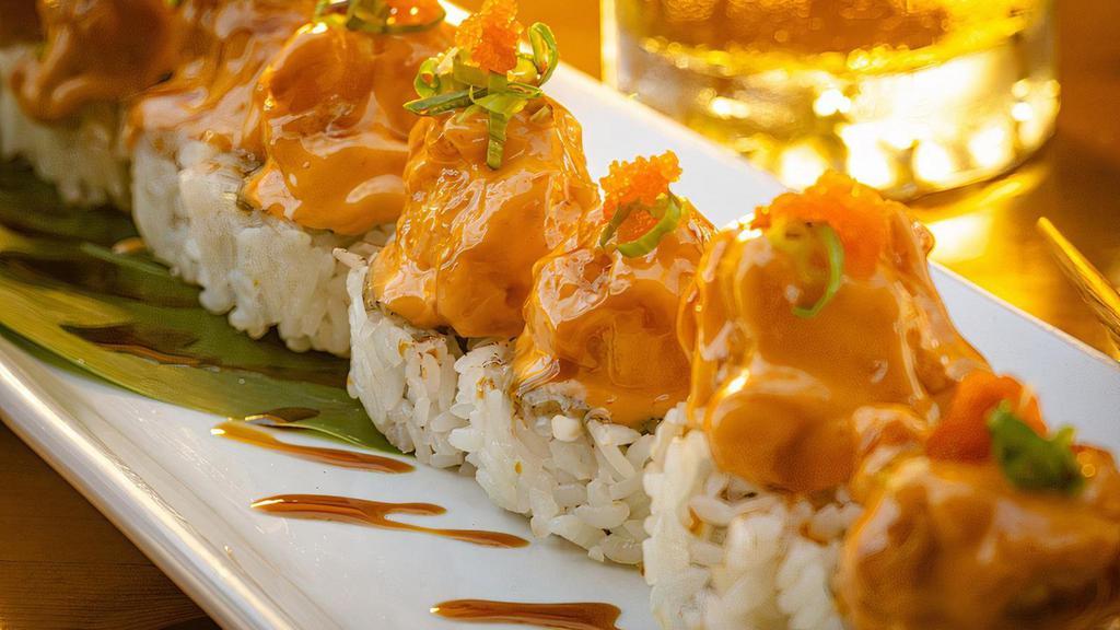Dynamite Langostino Roll · Baked spicy tuna roll  topped with creamy onion sauce, langostino tempura, masago, green onion, spicy mayo and eel sauce. All rolls come with avocado, sushi rice and seaweed paper