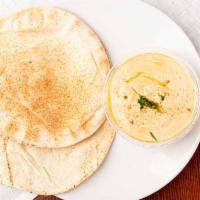 Hummus · Vegan. Mashed chickpeas blended with fresh made tahini paste, a touch of garlic, spices, lem...