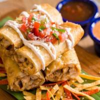 Crispy Flautas · Four crispy flour tortillas filled with grilled chicken and jack cheese. Topped with cotija ...