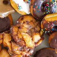 Regular Dozen Donuts · Regular Donuts include
Cake, Old Fashion, Devils Food, Bars, Twists, Jellies, French Cruller...