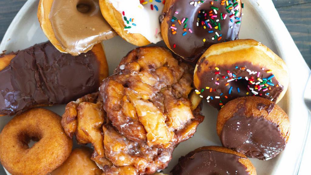 Regular Dozen Donuts · Regular Donuts include
Cake, Old Fashion, Devils Food, Bars, Twists, Jellies, French Crullers and Raised Rounds