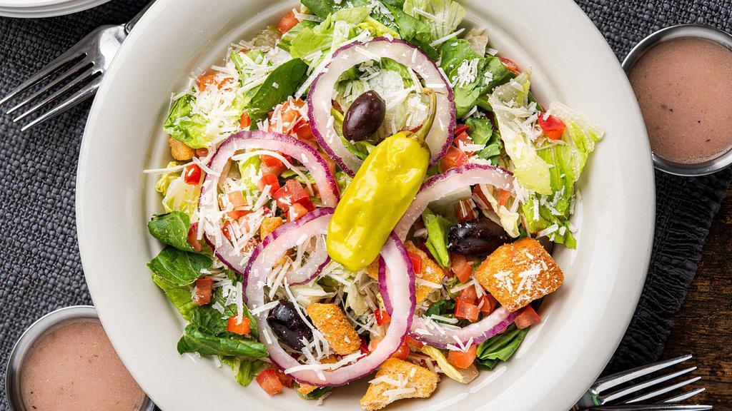 Italian Salad · A true Italian classic with romaine lettuce, iceberg lettuce, spinach, diced tomatoes, pepperoncini, Kalamata olives, red onions, parmesan cheese, croutons. Served with a zesty Citrus Balsamic Vinaigrette on the side.