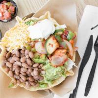 Tostada Salad · A  giant flour tortilla bowl filled with beans, lettuce, cheese, guacamole, sour cream and p...