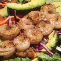 Cabo Shrimp Salad · Grilled shrimp skewers, romaine lettuce, avocado, tomatoes, red onions, pepitas & our lime v...
