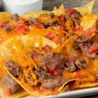 Miguel'S Jr. Nachos, Shredded Beef · Tortilla chips, refried beans, Española sauce, real cheddar cheese, tomatoes and choice of m...