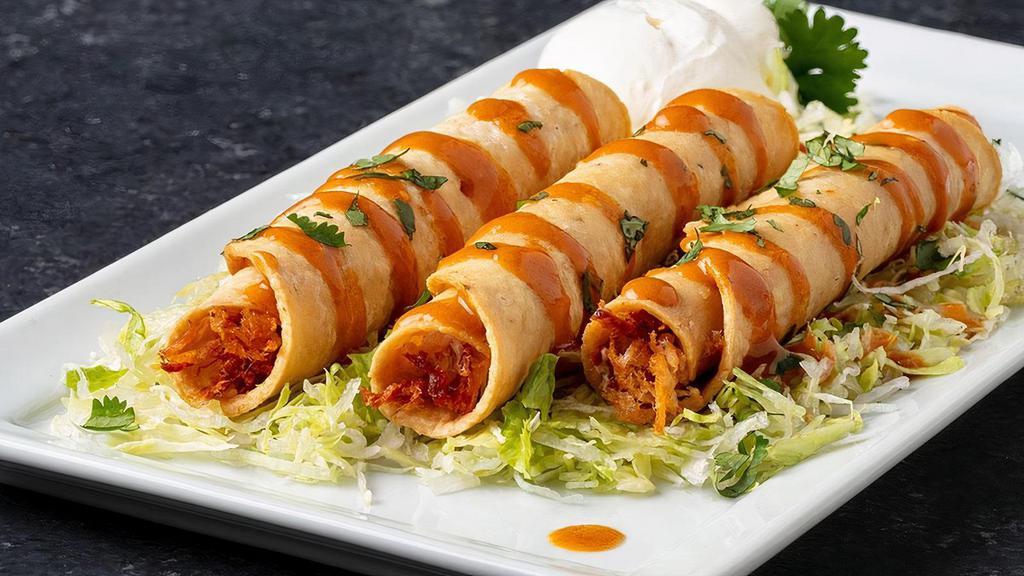 Fiery Taquitos, Chicken · Habanero hot sauce, cilantro, lettuce and sour cream served atop three shredded chicken taquitos