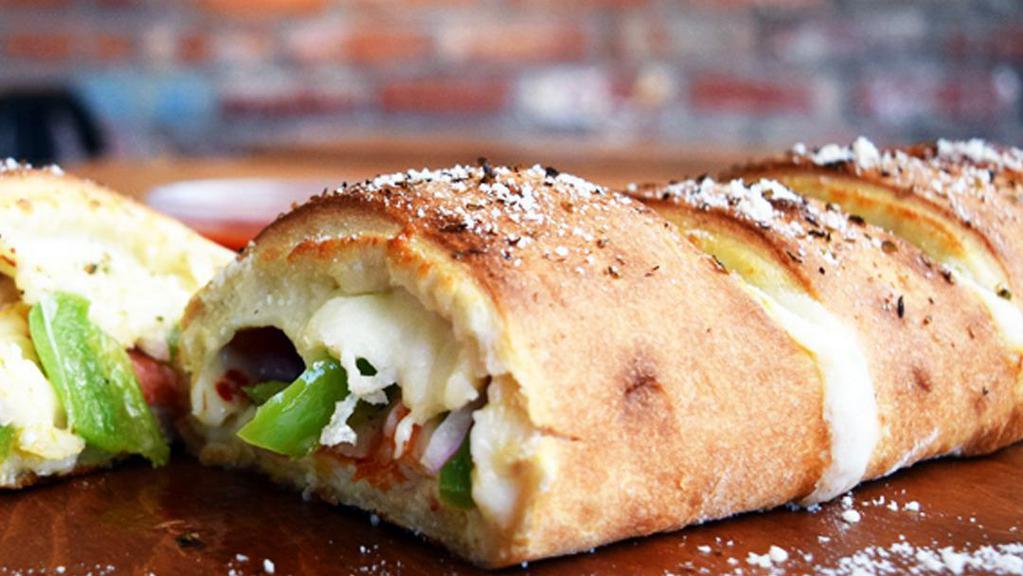 Full Stromboli · Full stromboli is served with green peppers, ham, cheese, pepperoni, red onions.