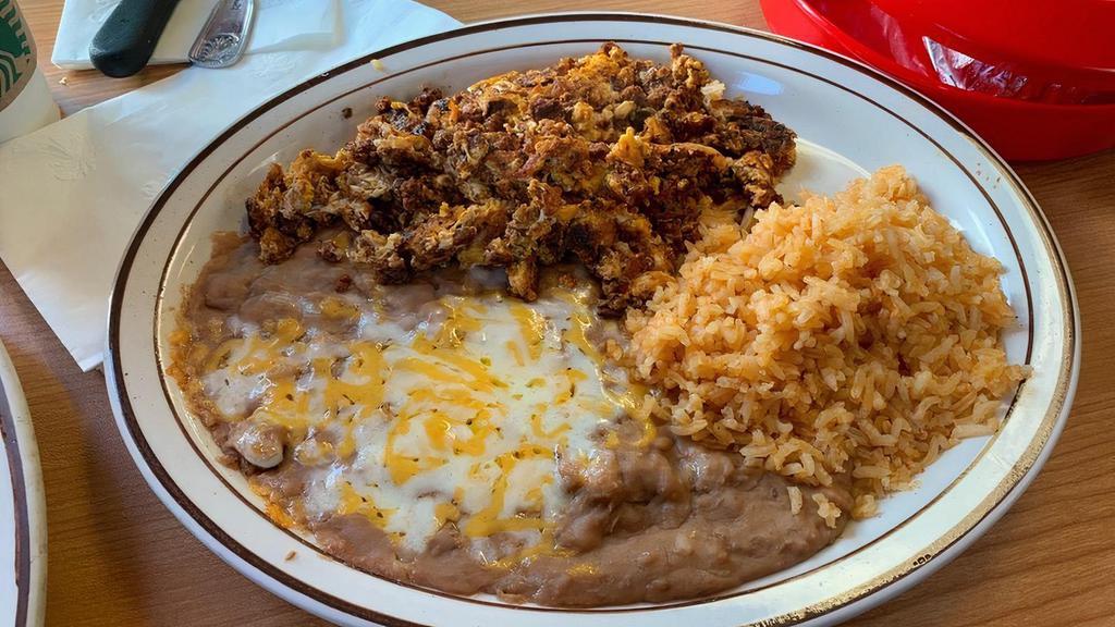 Chorizo Con Huevos · Chorizo (pork) scrambled with two eggs, topped with cheese. Served with beans and rice on the side and your choice of flour or corn tortillas.