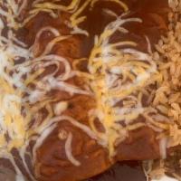 2 Chicken Enchilada · Flour tortillas stuffed with chicken and topped with enchilada sauce. Served with rice and b...