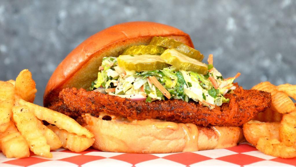Hot Chicken Sandwich · Crispy Nashville hot chicken served on a bun with dill pickles, coleslaw and our signature lucky sauce. Served with crinkle cut fries.