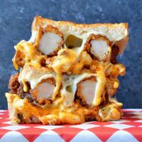 Nashville Hot Grilled Cheese  · A blend of creamy mixed cheeses topped with crispy Nashville chicken tenders, chopped bacon,...