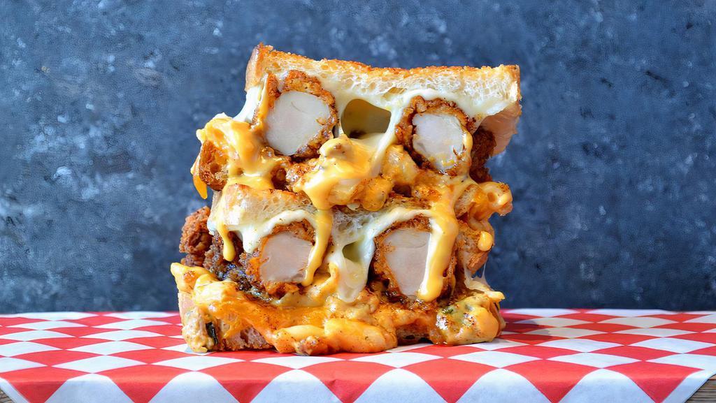 Nashville Hot Grilled Cheese  · A blend of creamy mixed cheeses topped with crispy Nashville chicken tenders, chopped bacon, and roasted green chilis.