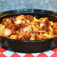 Nashville Hot Mac & Cheese · Creamy cheddar mac and cheese topped with crispy Nashville chicken tenders, chopped bacon, r...