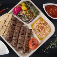 Beef Lule Kebab Plate · Two skewers of spiced ground beef, hummus, basmati rice, shepherd salad, grilled tomato and ...
