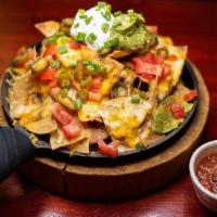Jackpot Nachos · Piled high with refried beans, Jack and cheddar cheese, tomatoes, jalapeños and topped with ...