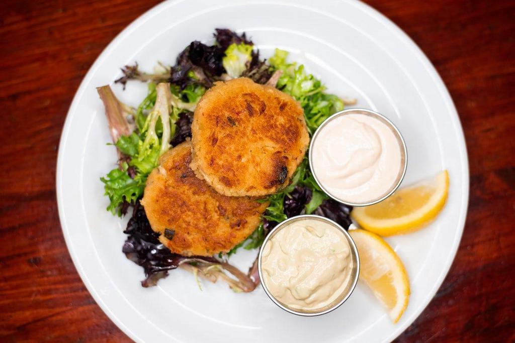 Jumbo Lump Crab Cakes · Pan-seared, loaded with jumbo lump crab meat and a bleand of seasonings. Served with housemade avocado cream and Joe's mustard sauce.