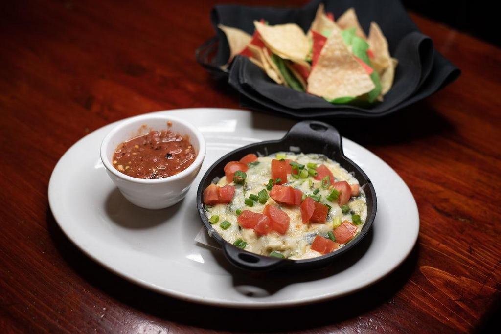 Spinach & Artichoke Dip · A rich and creamy four-cheese blend with fresh spinach and artichoke hearts. Served with wood-roasted salsa and crisp tortilla chips.