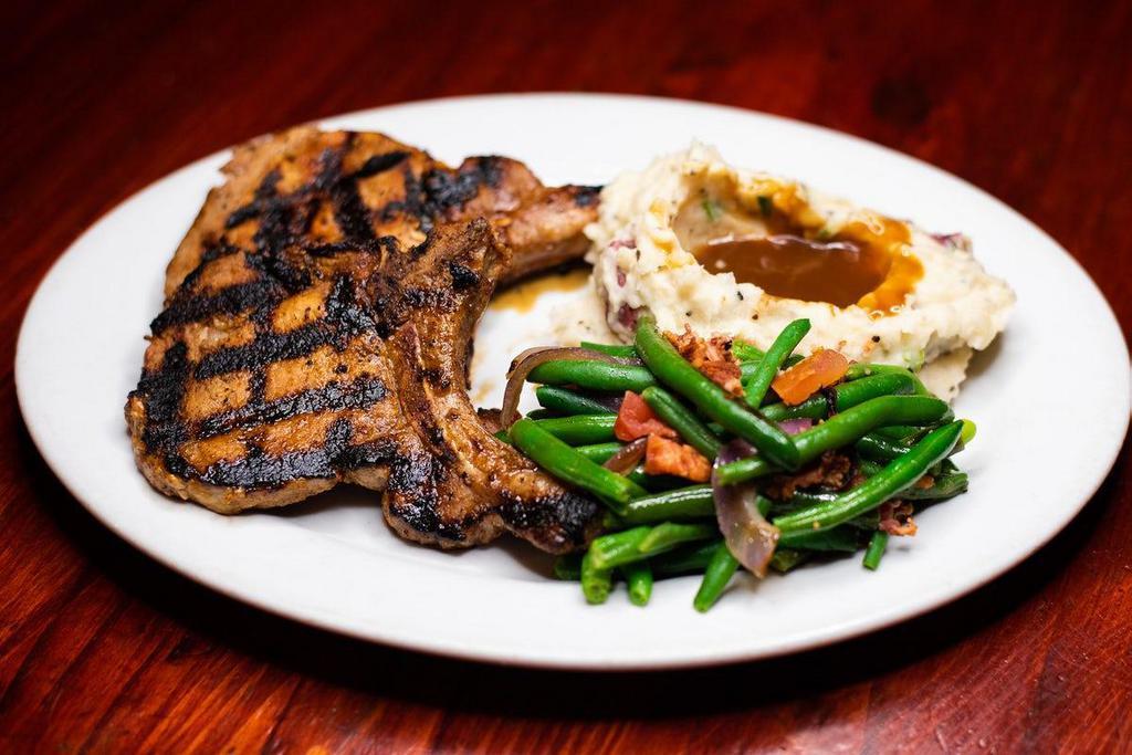 Pork Chops · Two center cut chops grilled over an almond wood fire. and paired with Mountain Mashers and Blue Lake Green. Beans.