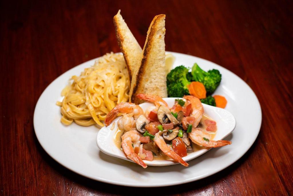 Shrimp Scampi · Six jumbo shrimp pan-seared with white wine, tomatoes, mushrooms, butter, lemon and a hint of garlic served with a zesty fettuccine Alfredo and fresh veggies.