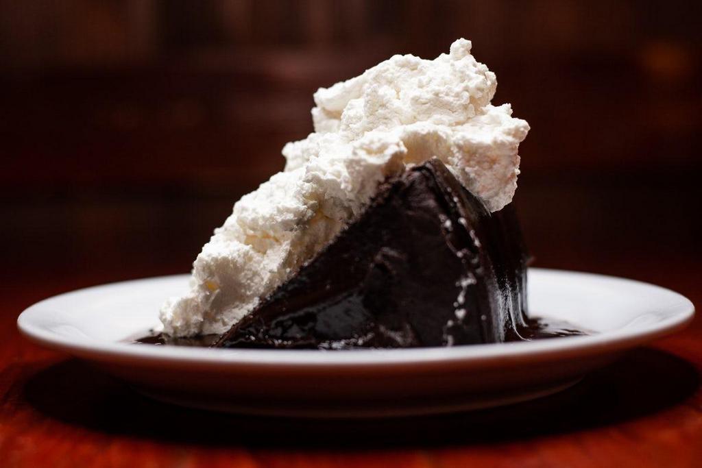 Ski Jump Chocolate Cake · A rich six-layer chocolate cake topped with fresh whipped cream and homemade chocolate sauce.
