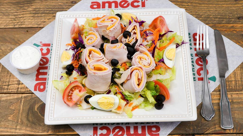 Chef Salad · A savory chef salad made with fresh iceberg lettuce, red cabbage, tomato, hard-boiled egg, black olives, turkey, ham and American cheese.