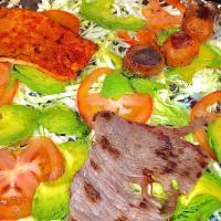 Tlayuda With 3 Meat · Large tlayuda with black beans, string Oaxaca, cheese, green cabbage, avocado, tomato and a ...