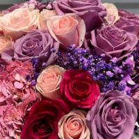 Paris To Rome  · A mix of purple , lavender and pink hydrangeas and roses in a beautiful vase.

Each arrangem...