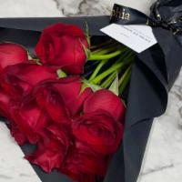 The Red Bouquet · A dozen red roses wrapped in paper. 

Each arrangement includes a  card with a typed message...