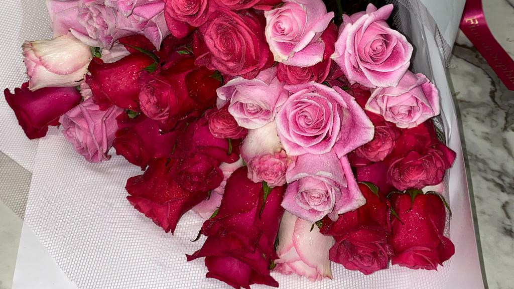 The Pink Bouquet · 12 pink roses wrapped in paper.
Each arrangement includes a  card with a typed message.
**If you would like a message on the card please type it on 