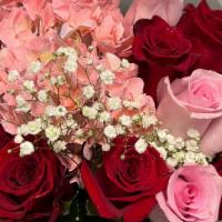 The Pink And Red Bouquet  · A mix of red and pink roses with a pink hydrangea. 12 roses. Wrapped in our  black paper.
Ea...