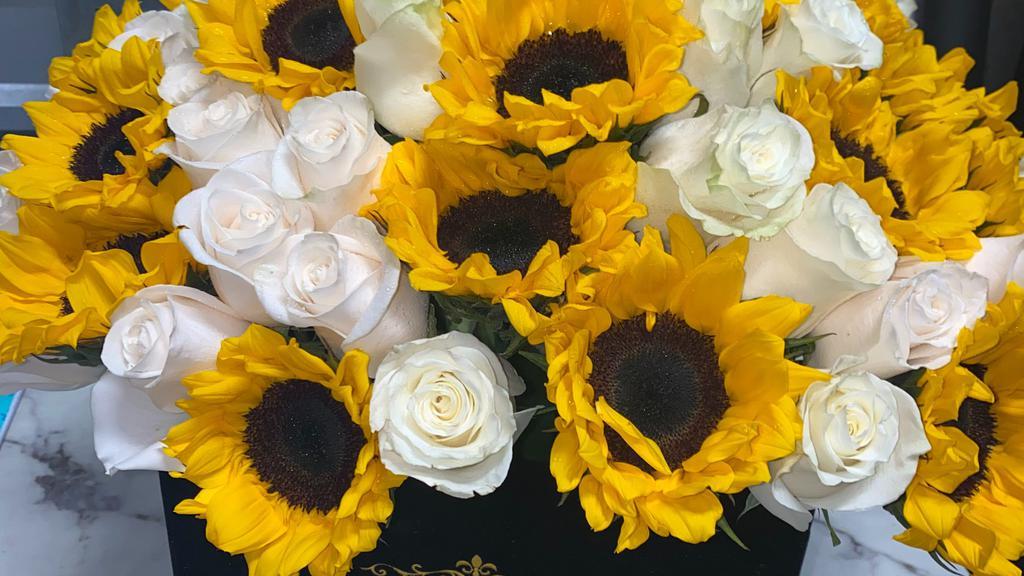 Beautiful Sunflowers · A mix of sunflowers and white roses in a luxurious black box.

Each arrangement includes a  card with a typed message.
**If you would like a message on the card please type it on 