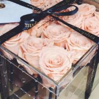 Very Peachy · 36  peach preserved roses in an acrylic box.

Each arrangement includes a  card with a typed...