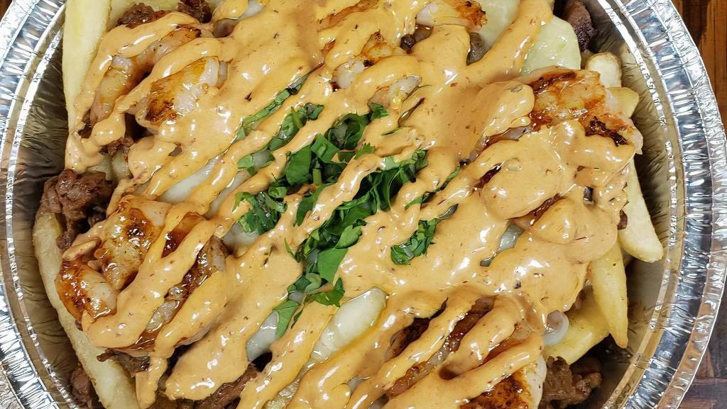 Earthquake Fries Plate · Protein: marinated grilled shrimp with seasoned sliced steak served over rigged fries. Toppings: freshly chopped cilantro, Monterey jack cheese, drizzled with our house made chipotle sauce.