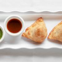 Vegetable Samosa · Triangular shaped patties filled with potatoes, peas. Flavored with special herb to give fla...