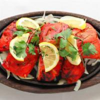 Tandoori Chicken · Marinated chicken with herbs, yogurt, spices tenderly cooked in clay oven.