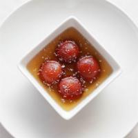 Gulab Jaman · Rice pastry balls, delicate insides with a lightly fried crust, soaked in honey syrup.