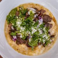 Steak Taco · Grilled flap meat topped with chimichurri, cotija cheese, red onions and cilantro.