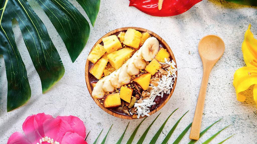 Surf’S Up Tropical Bowl · Acai bowl topped with granola, bananas, pineapple, mango, shredded coconut, and honey.
