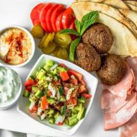 Fanous Appetizer Plate · Hummus, tzatziki, falafel, salad shirazi, mortadella, pickles, tomatoes, and pita bread.